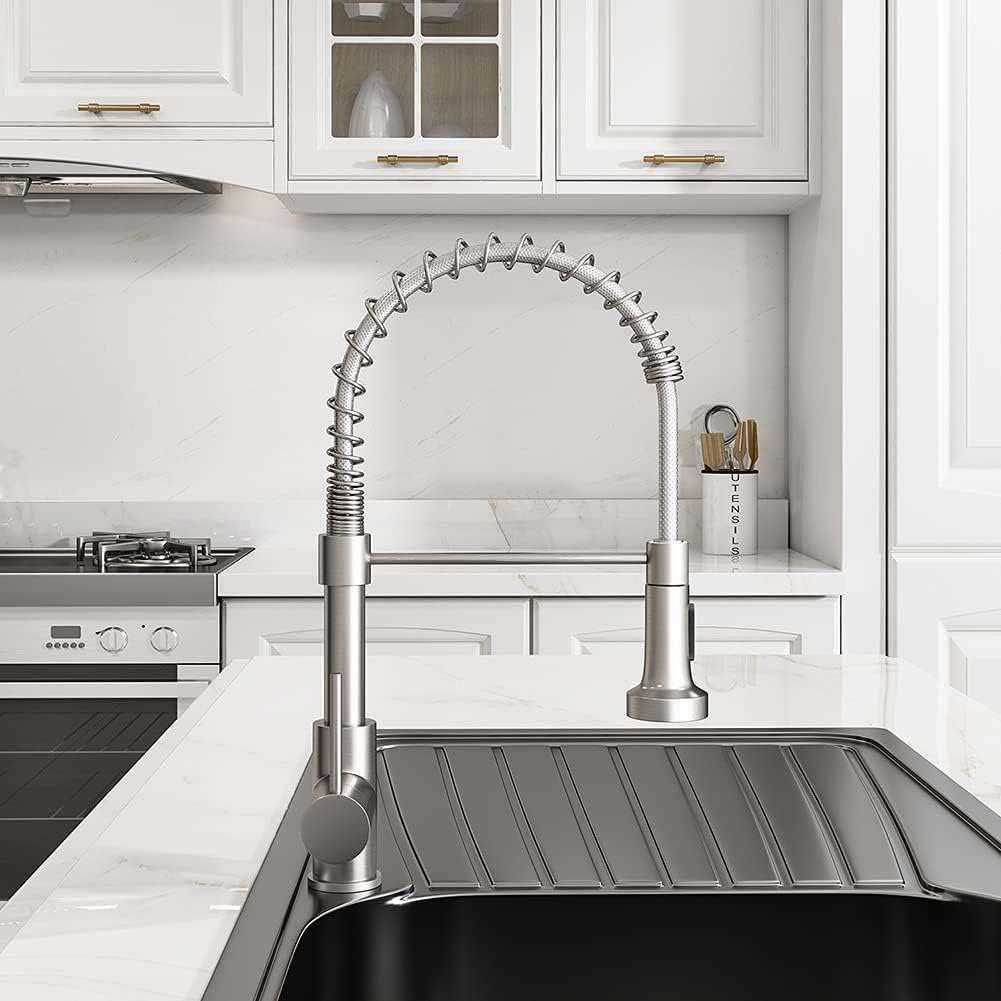 Commercial spring faucet installed on white marble counter with drying rack sink